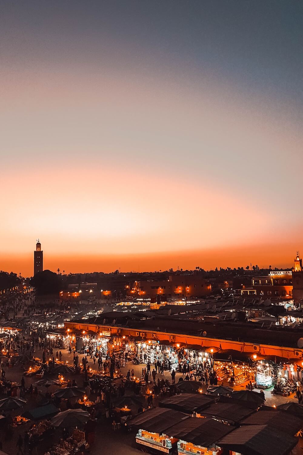 Couple experiencing the charm of Marrakech Medina during their romantic proposal package, embracing the vibrant culture.