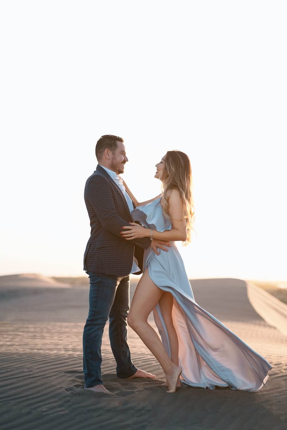 Heartfelt proposal moment with breathtaking desert backdrop and setting sun