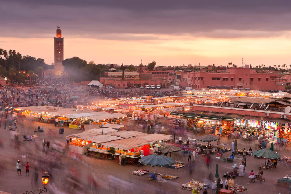 Couple experiencing the charm of Marrakech Medina during their romantic proposal package, embracing the vibrant culture.